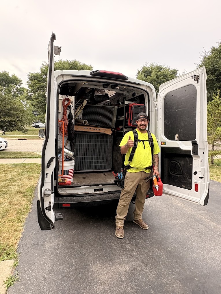 Smiling Optimized Air technician at a fully stocked HVAC service van
